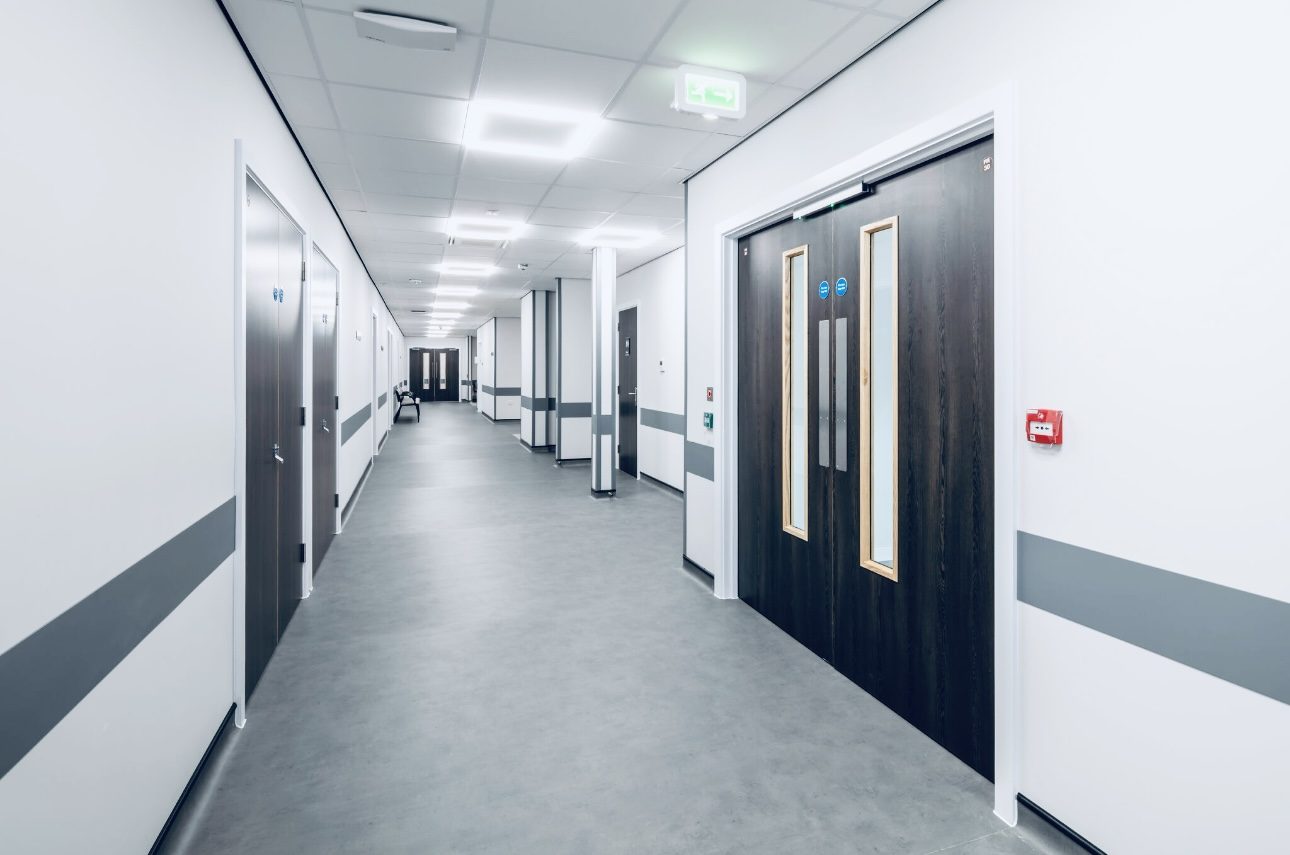 NHS healthcare flooring installation — welded safety vinyl with cap and cove detail in a clinical treatment room